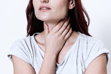 Girl raised her chin and hold on to a sore.  clipart
