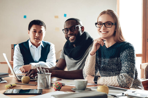 Woman with colleagues sitting at the table. 