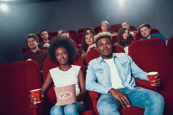 African couple with popcorn watching movie. human — Stock Photo, Image