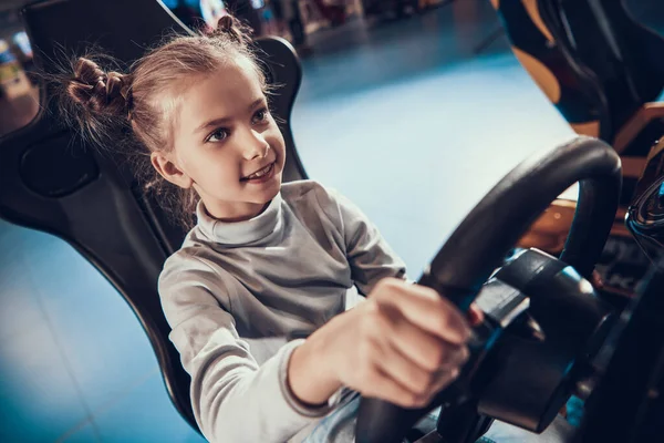 Menina dirigindo um carro de brincar no centro. — Fotografia de Stock