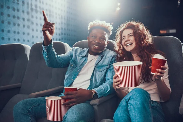 A man shows something to woman on a movie screen. — Stock Photo, Image