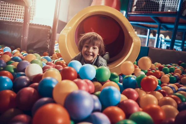 プールに横になってカメラを見ている男の子. — ストック写真