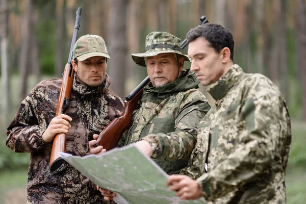 Men Studying Map Family Hunt in Forest Recreation.