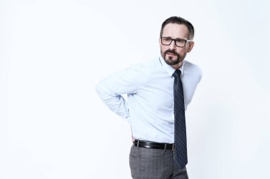 Sırtı ağrıyan beyaz gömlekli bir adam..