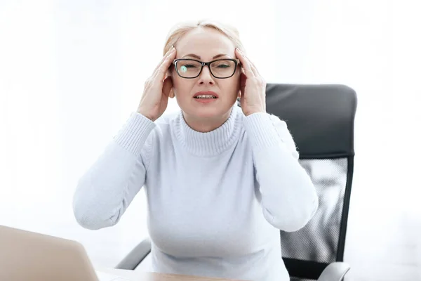 Woman sitting in chair with severe pain in head. — Stock Photo, Image