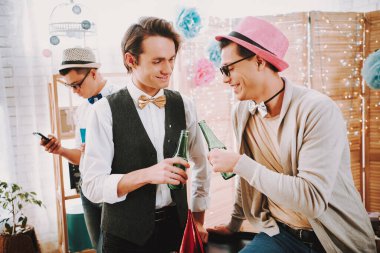 Partide iki eşcinsel şişe tokuşturur..