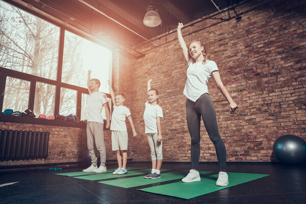 Женщина улыбается и поднимает руки. 