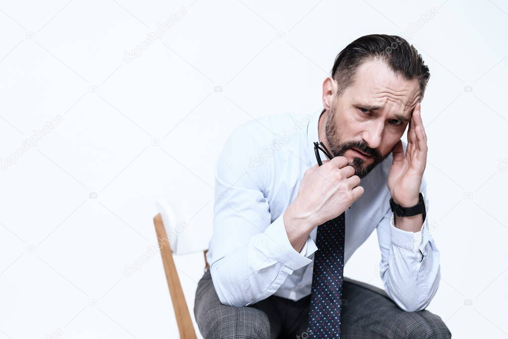 A man has a headache on a white background.