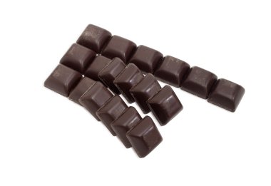Slices of dark chocolate on a light background