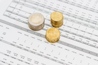 Euro coins different denominations stacked on the data table