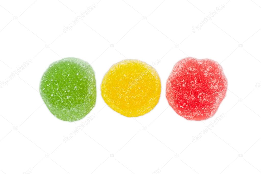 Three multi colored fruit jelly candies on a light background
