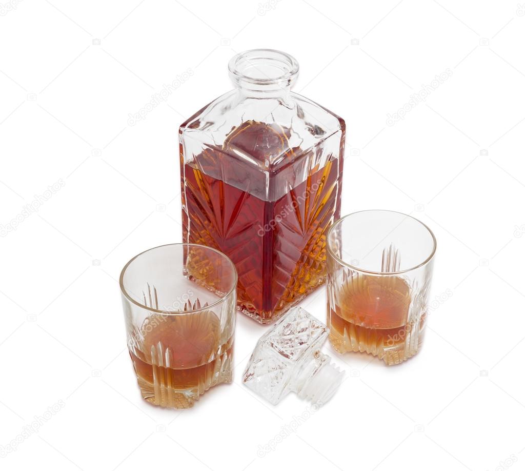 Decanter and two glasses with whiskey on a light background