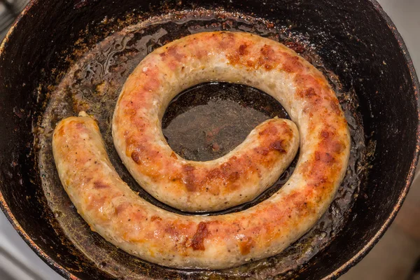 Grilled homemade sausage in a frying pan — Stock Photo, Image