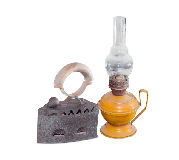 Old charcoal iron and kerosene lamp on a light background — Stock Photo, Image