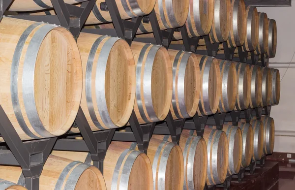 New oak wine barrels on a shelving — Stock Photo, Image