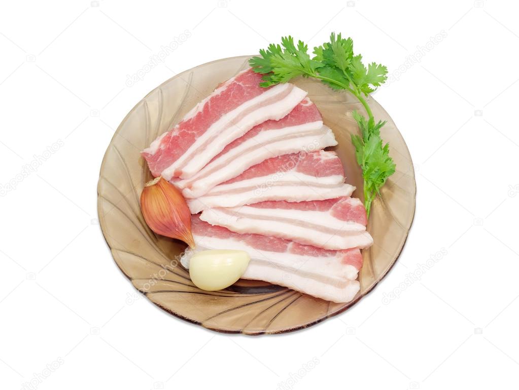 Uncooked streaky bacon, garlic and sprig of cilantro