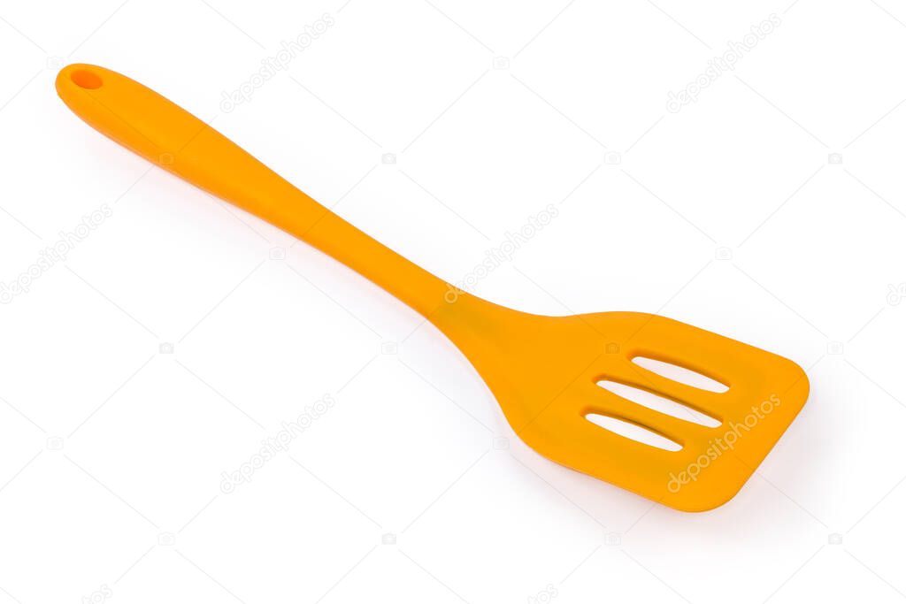 Yellow plastic kitchen spatula with bendable working part used to mix, lift and flip food during cooking for non stick pans on a white background