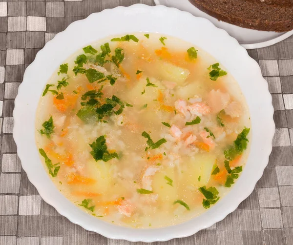 Rainbow trout clear soup with chunks of fish in the white bowl on a table, top view — Stock Image Rainbow Trout Clear Soup Chunks Fish White Bowl Table Top Stock Picture