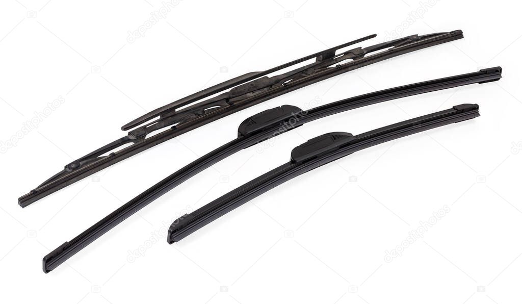 Pair of new modern frameless car windshield wipers blades different lengths against a single traditional used wiper blade on a white background
