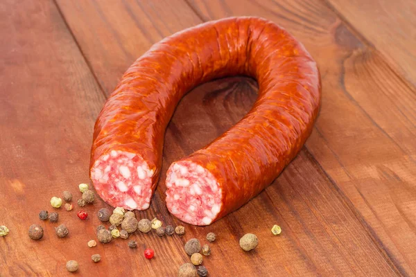 Partly Cut Boiled Smoked Sausage Curtailed Ring Scattered Different Pepper — Stock Photo, Image