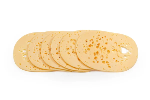 多くの穴を持つスイス型チーズの大きな薄切り 白い背景にチーズの目と呼ばれます トップビュー — ストック写真