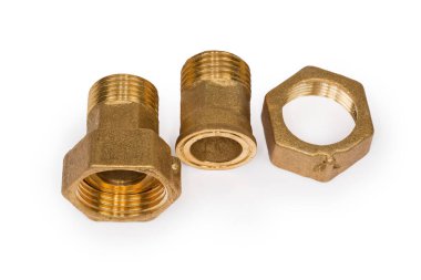 Beyaz arka planda uygun fındıkla boruları birbirine bağlayan iki pirinç işlemeli boru.