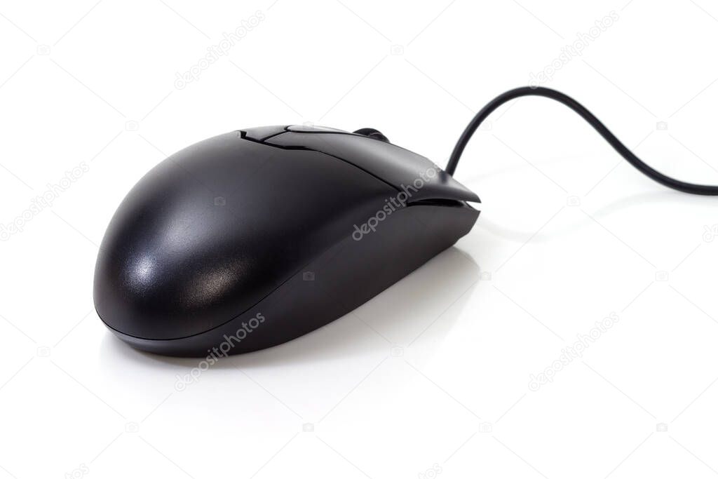 Black typical wired optical computer mouse on a white surface, close-up in selective focus