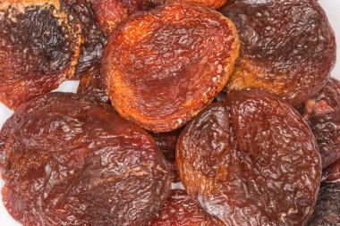 Dried smoked apricots, top view close-up, background