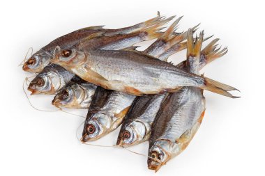 Heap of salted and air-dried roach fish on string on a white background, top view