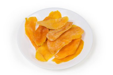 Dried slices of mango pulp on white dish on a white background