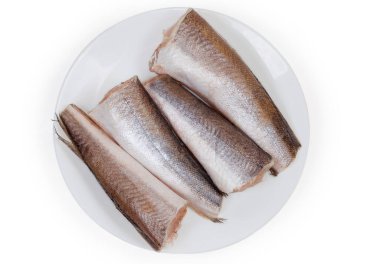 Kafaları ve kuyrukları olmayan, beyaz bir arka planda balık pullarından temizlenmiş, pişmemiş Arjantin hake cesetleri.