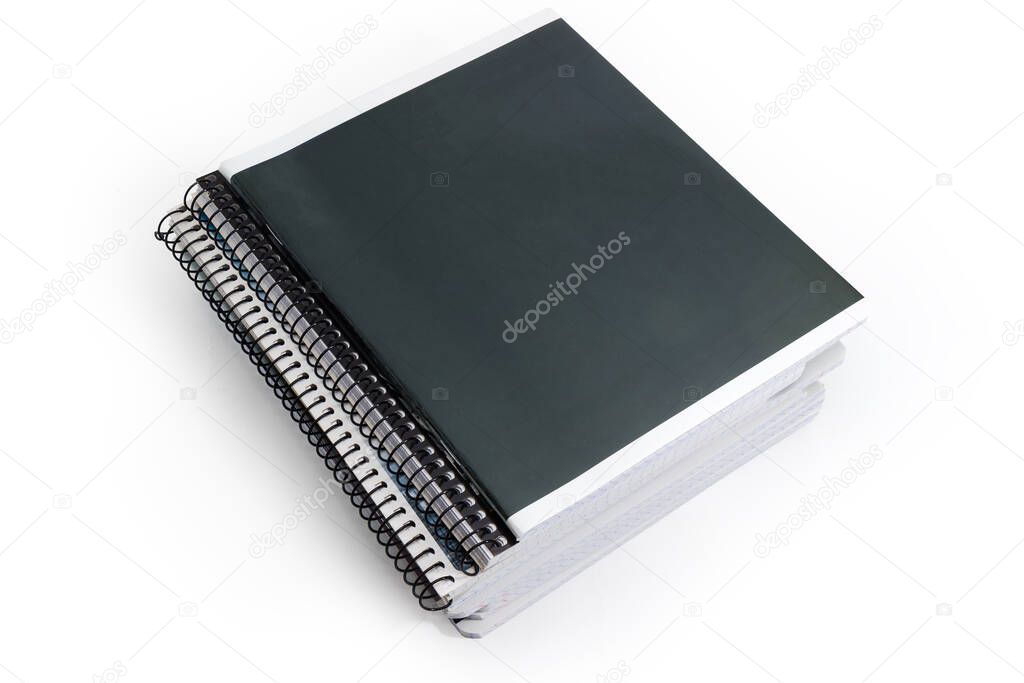 Stack of the different closed school exercise books with ordinary and spiral bindings on a white background