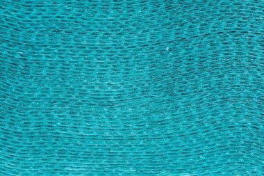 Fragment of stack of the gray green unbleached soft paper towels, view from the butt-end with cut side of stack close-up