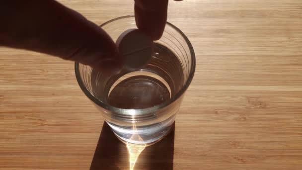 Su bardağında coşkun tabletin çözünmesi. — Stok video