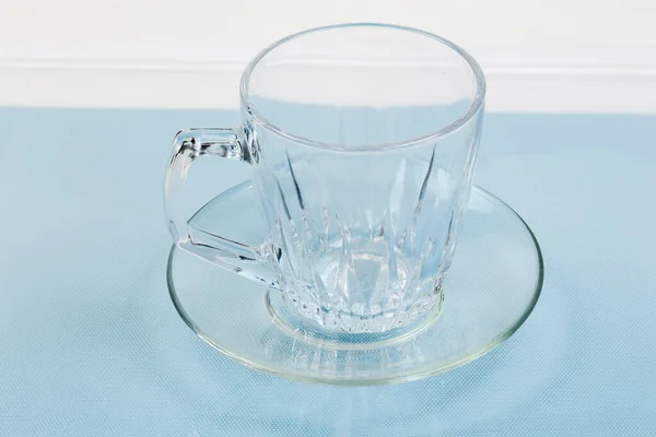 Empty Transparent Glass Cup Handle Glass Saucer Blue Surface — Stock Photo, Image