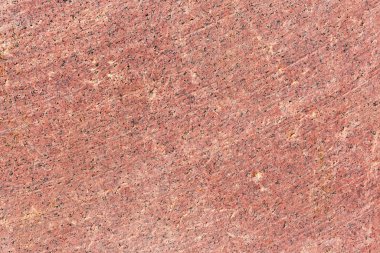Kırmızı granit bloğun düz tarafı, taş kesme aracının çalışma izleri yakın çekim, doku, arkaplan 