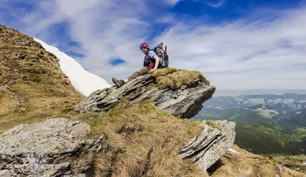 Jonge toeristische op de top van een berg — Stockfoto