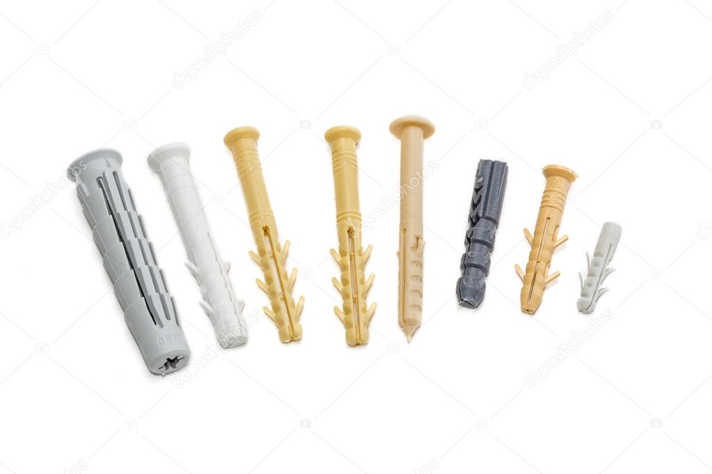 Several plastic wall plugs on light background