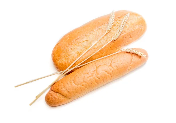 Two various loafs of bread and wheat spikelets — Stock Photo, Image