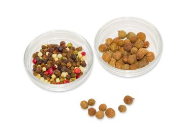Two glass containers with mixture of peppers and allspice 