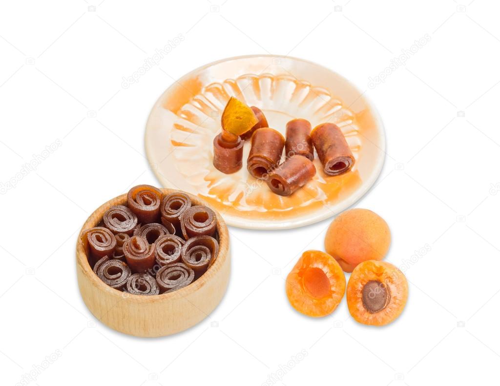 Apricot pastila and two ripe apricot on a light background