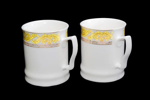 Two white cups on a black background — Stock Photo, Image