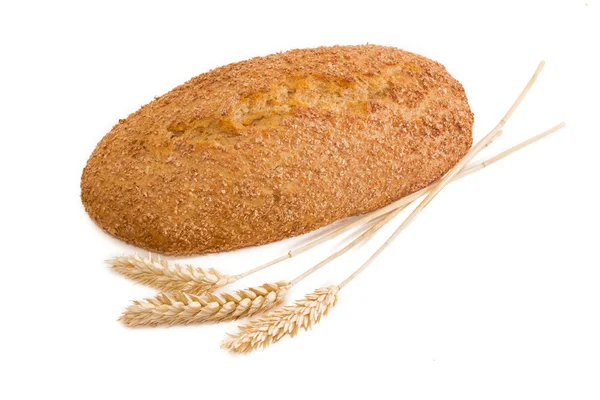 Bread with bran and wheat spikelets on a light background — Stock Photo, Image