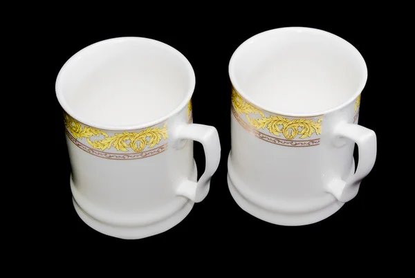 Two white cups on a black background — Stock Photo, Image