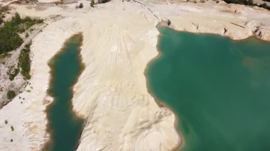 Waste rock dumps, artificial lakes in ilmenite quarry, aerial view
