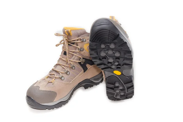 Light brown trekking shoes on a light background — ストック写真