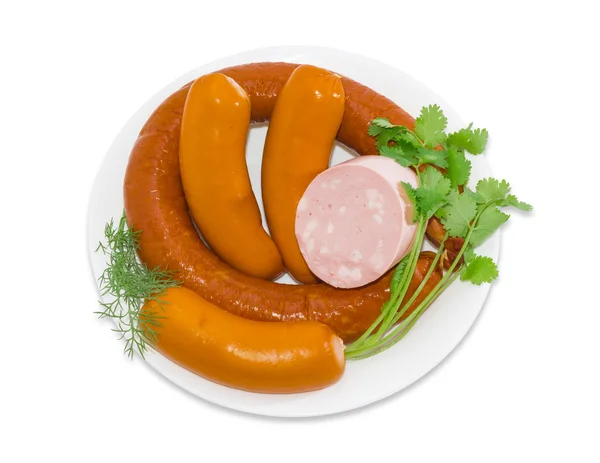 Several different varieties of sausages on a white plate — Stock Photo, Image