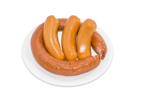 Sausage and three uncooked bangers on a light background — Stock Photo, Image