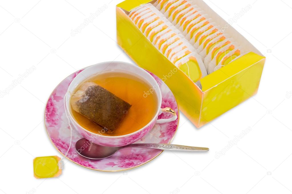 Cup of tea, spoon, saucer, box of tea bags