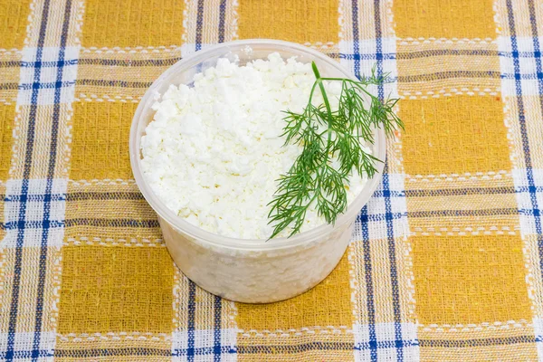 Container of cottage cheese with branch of a dill — Stock Fotó